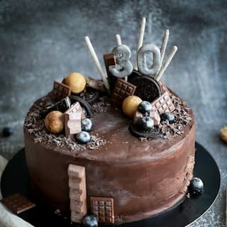 Photo of a decorated chocolate cake with a 30 topper